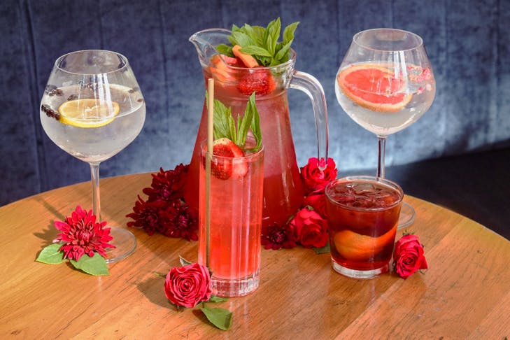 gin cocktails and gin sangria lined up on a wooden table